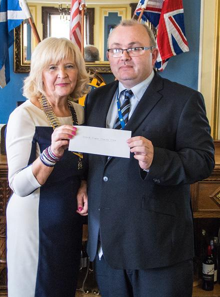 Happy Smiles on Disbursement Day - Gordon McGlynn receives the cheque on behalf of Marie Curie Cancer Care