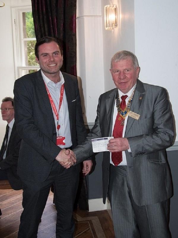 Visit by RIBI President Peter Davey - President Bill Knox receives a donation from Craig Collins, the manager of Clydeport.