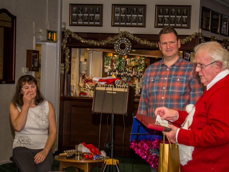 Members' Christmas Party - Yvonne has to wipe away a tear as Ian presents a small gift. Matt's eyes are firmly on the cheque in his other hand!