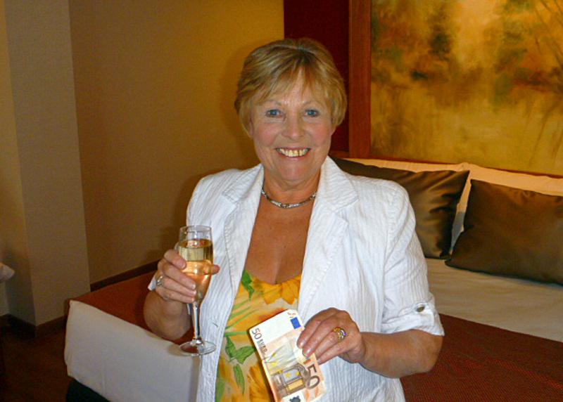Club weekend away - Carol with wine and 50 euros in hand.