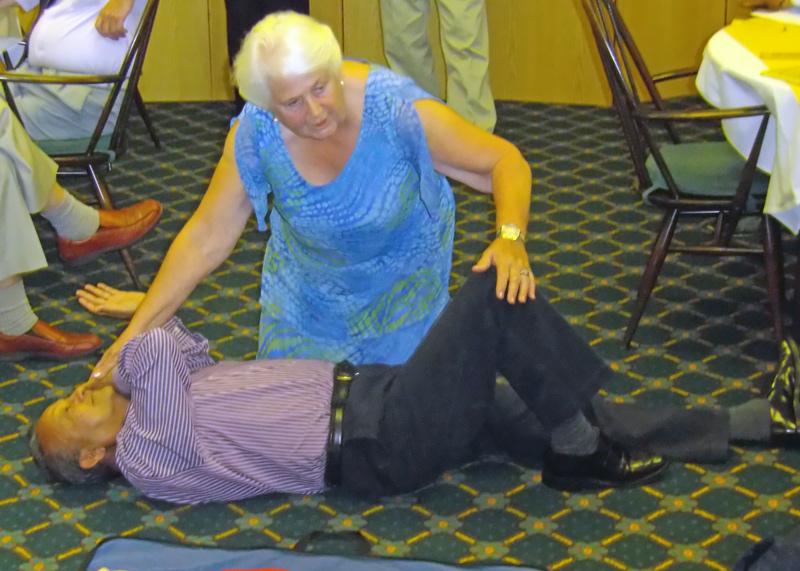 Speaker Evening - Ann showing how to turn a patient over - in this case Satish.