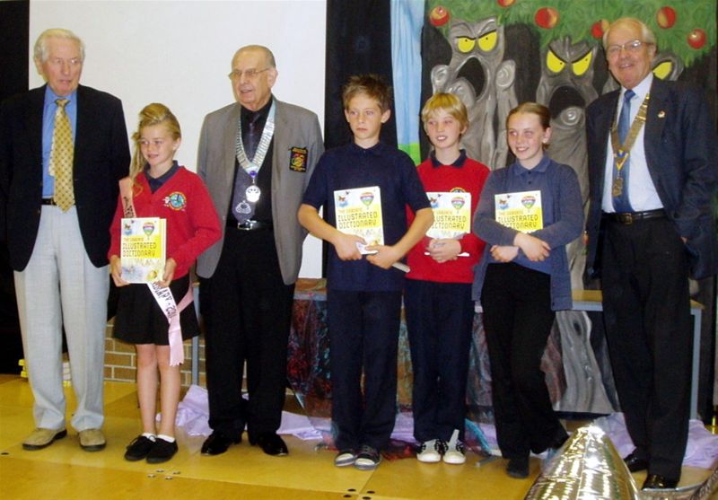 Dictionary Presentations - District Governor Tony, President Brian and A G John McLoughlin with some of the pupils of Redby School.