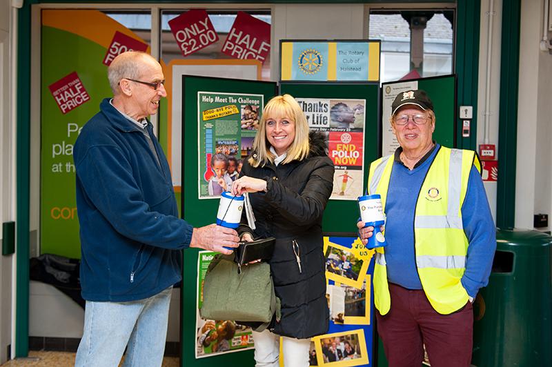 Rotary Week - End Polio Now  - Rotarian's Alan deBank and David Hume receive a donation from a caring member of the public.