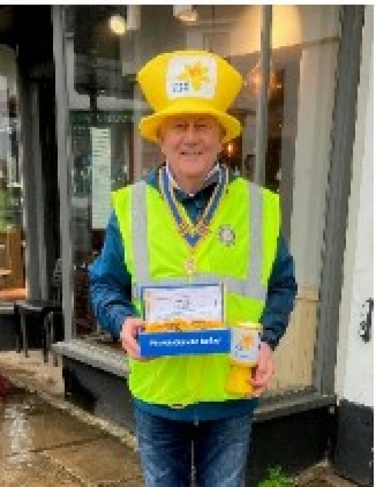 Rotary has a long association with Marie Curie, and helping the charity with their annual Daffodil Day has become an important part of the Rotary year. - Colin Ullmann-Jones ( pictured ) is President of the Rotary Club of Edenbridge
and Westerham and one of the Rotary team collecting in Westerham on a windy
Saturday in April.