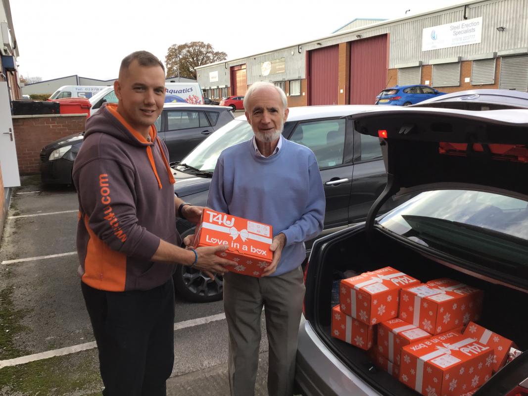 Collecting foils from medication - President Robin handing over some of the 36 filled shoeboxes for distribution by Teams4U