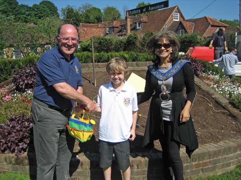 25-31 May 2012 - The 4 winning flowerbed designs are planted - Station Road flowerbed - Rotarian Roger Wyborn, accompanied by Mayor Mimi Harker, presenting Finley with his gift.