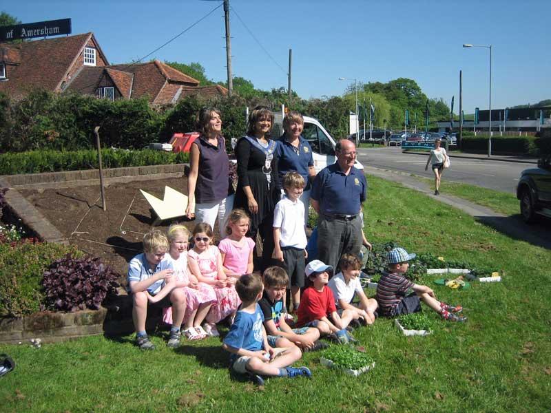 25-31 May 2012 - The 4 winning flowerbed designs are planted - Station Road flowerbed - Cllr Amanda Lamont,  Mayor Mimi Harker, Rotarian Pat Armstrong, Finley, Rotarian Roger Wyborn and children from St Mary's School Environmental Club.