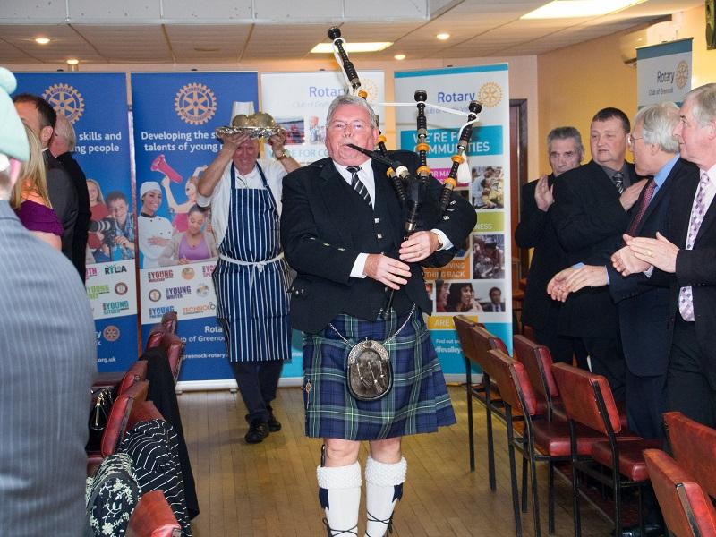 Greenock Rotary Annual Burns Supper - Piper Tommy Trotter pipes in the haggis which is being held aloft by caterer Tony Buckley