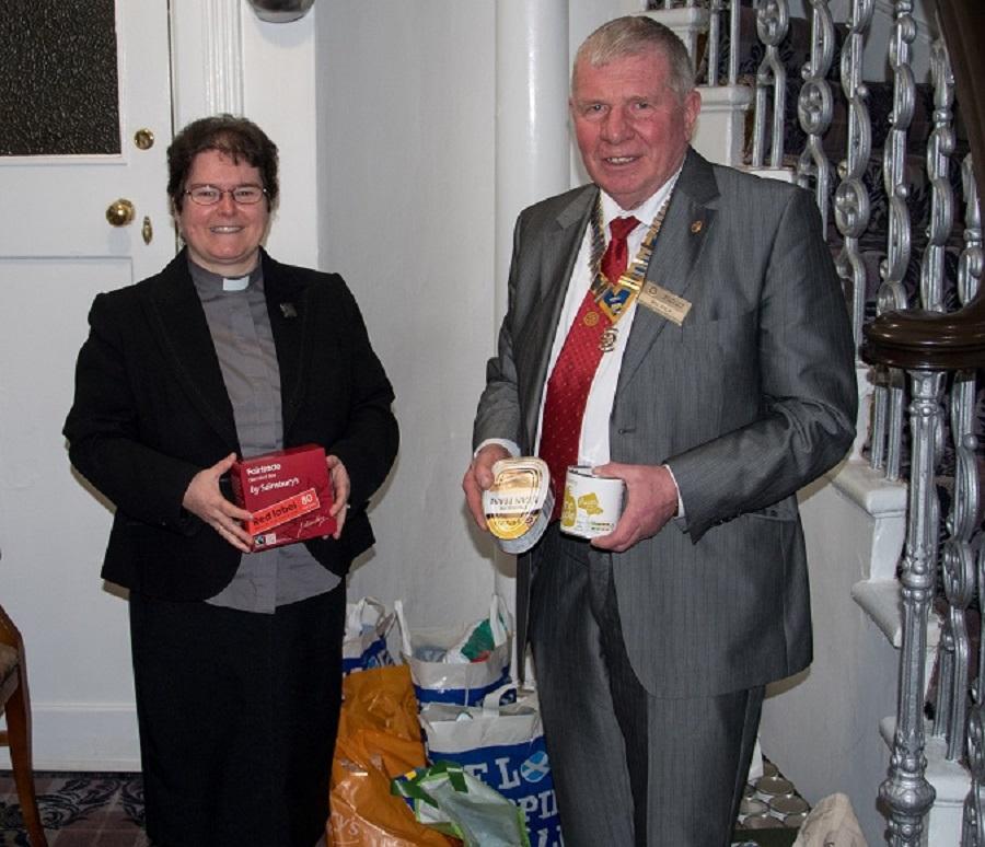Visit by RIBI President Peter Davey - Rtn Branwen Rees receives donations of food for the URC Foodbank from President Bill Knox 