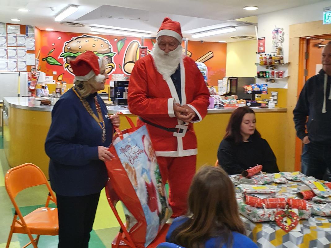 Young Carers at Christmas - Santa giving out the presents to the Minehead Young Carers