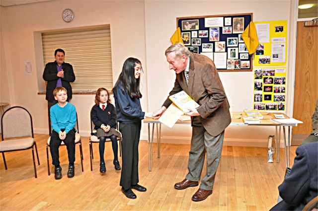 27 January 2011 - Christmas Story Competition winners receive their prizes - Yusra Malik of Chesham Bois C of E Combined School receives her prize from David Allen, President of Chesham Rotary Club. Yusra was 3rd in the Year 4 & 5 category.