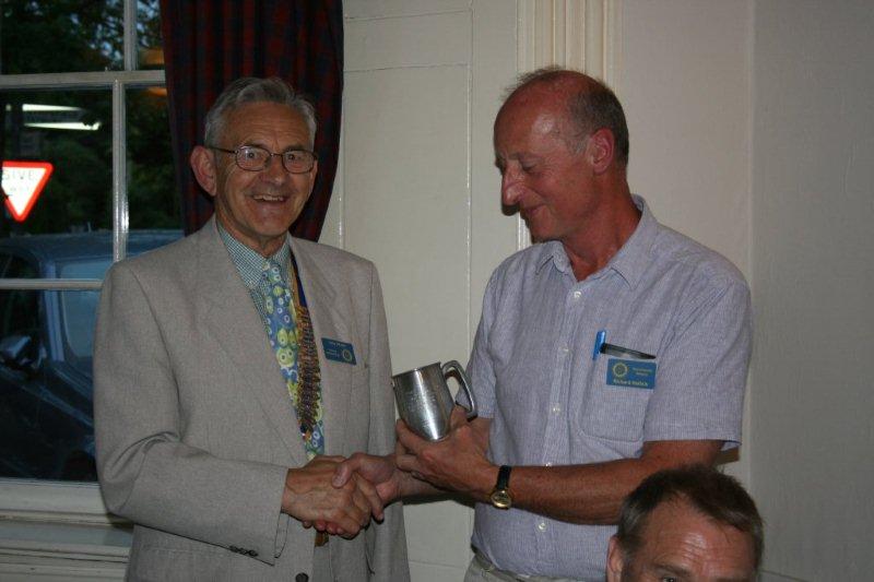 Handover Meeting - Adrian presents trophy to Richard Hollick for the beest overall sporting peerformance.