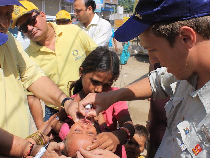 Eradicating Polio - Rotary volunteers help with handing out polio drops to children